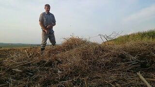 The farmer in rubber boots pees on the straw pile - porn video